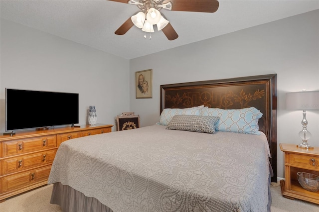 bedroom featuring a ceiling fan and light carpet