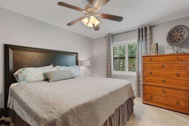 bedroom featuring a ceiling fan and light colored carpet