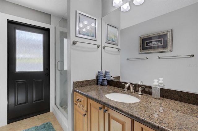 bathroom featuring a stall shower, tile patterned flooring, and vanity