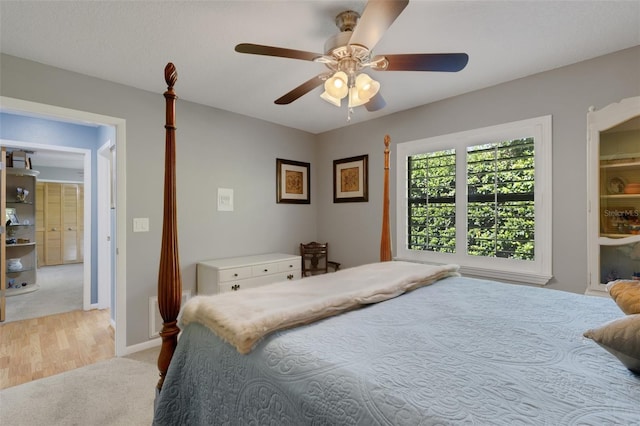 bedroom featuring light carpet, ceiling fan, and baseboards