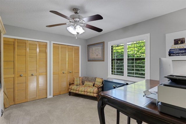 office with carpet floors and a ceiling fan