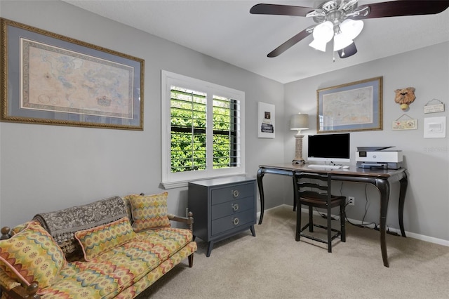 office featuring light carpet, ceiling fan, and baseboards