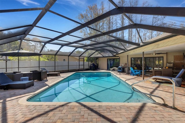 view of pool featuring a fenced in pool, glass enclosure, and a patio area