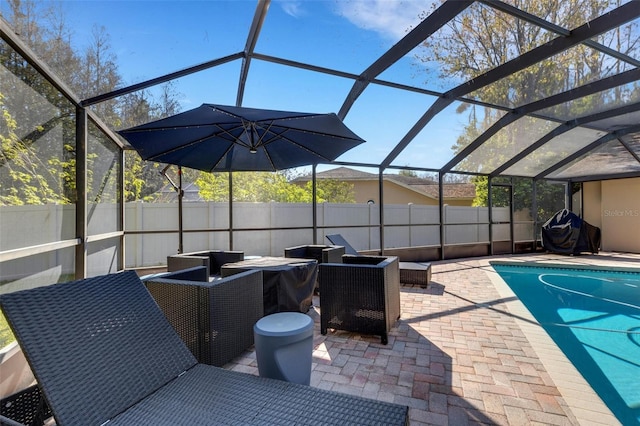 view of patio / terrace featuring a lanai, fence, and a fenced in pool