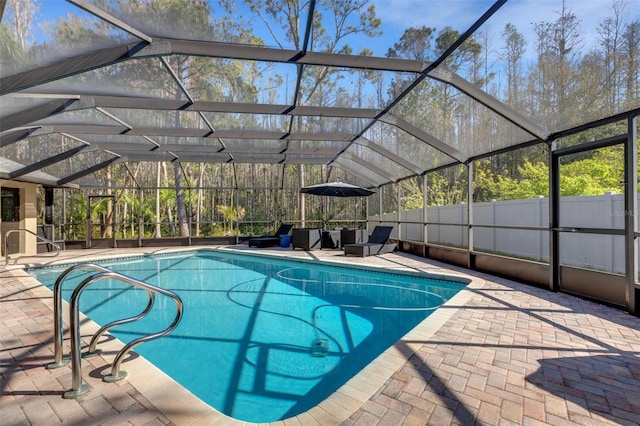 view of swimming pool with a fenced in pool, glass enclosure, a patio area, and fence