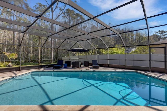 view of swimming pool with a lanai, a patio area, and a fenced in pool