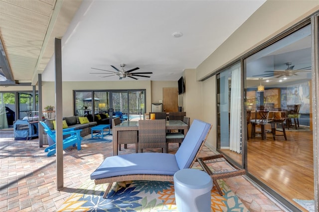 view of patio / terrace with an outdoor hangout area, a ceiling fan, and outdoor dining space