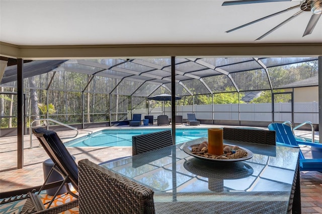 view of pool featuring glass enclosure, a patio area, fence, and a fenced in pool