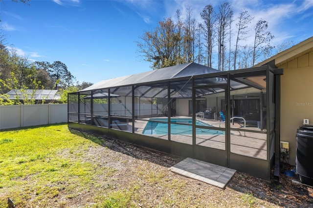 view of pool with a patio, central AC, fence, a yard, and a fenced in pool