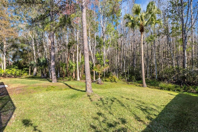 view of yard with a view of trees