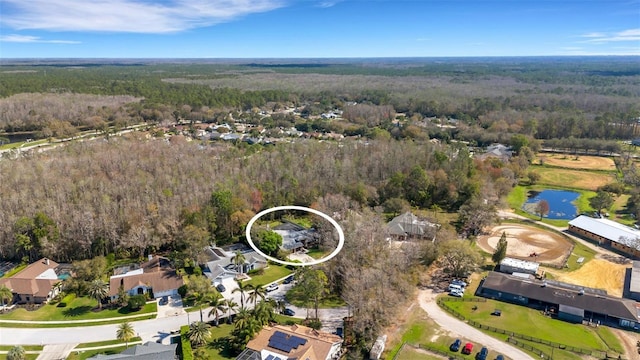 bird's eye view with a forest view and a water view