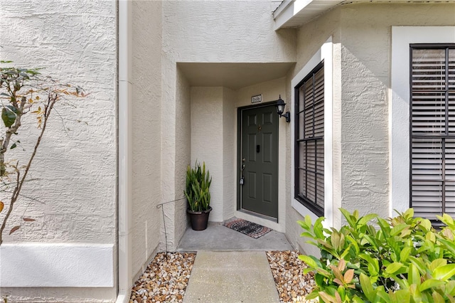 property entrance with stucco siding