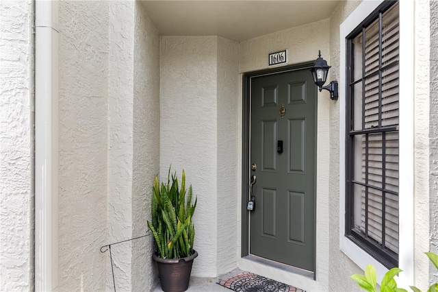 doorway to property with stucco siding