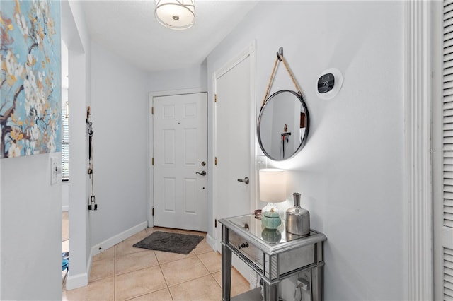 entrance foyer featuring light tile patterned floors and baseboards