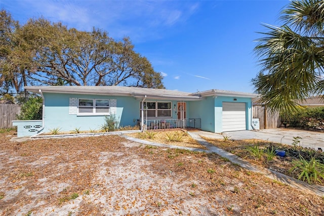 ranch-style home featuring concrete driveway, an attached garage, fence, a porch, and stucco siding