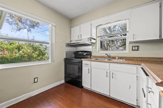 kitchen featuring dark wood-type flooring, white cabinets, a sink, under cabinet range hood, and black / electric stove