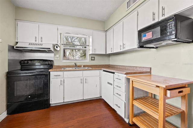 kitchen featuring dark wood-style floors, white cabinets, a sink, under cabinet range hood, and black appliances