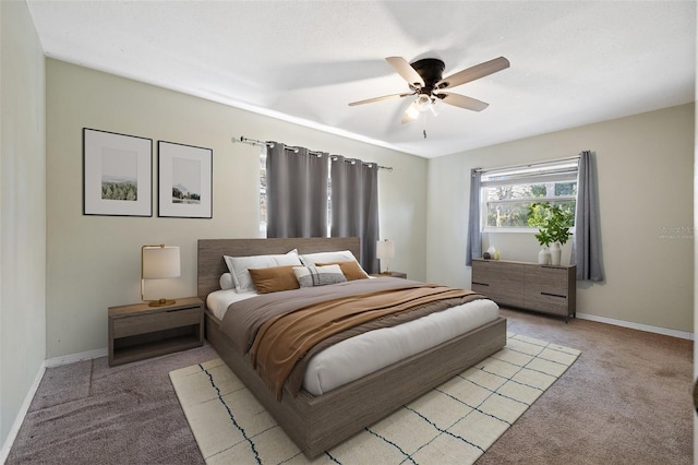 bedroom with light carpet, ceiling fan, and baseboards