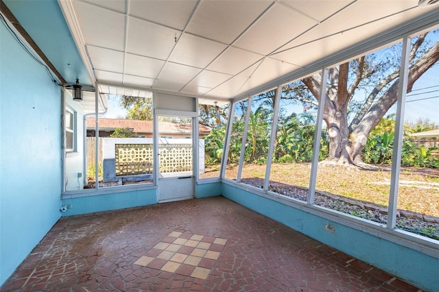 unfurnished sunroom featuring a paneled ceiling