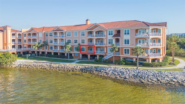 exterior space featuring a water view and a chimney