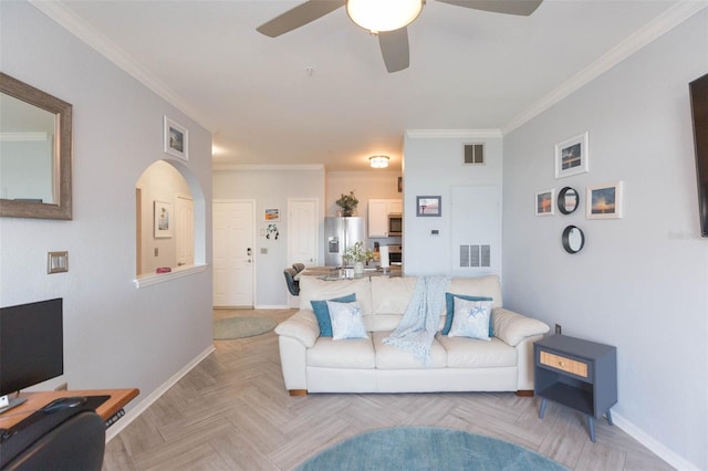 living room featuring visible vents, crown molding, and baseboards