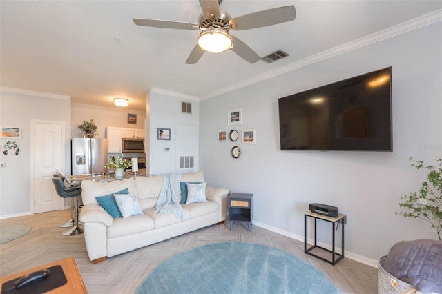 living area with baseboards, visible vents, and crown molding