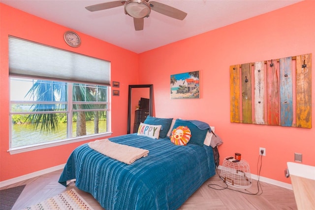 bedroom featuring ceiling fan and baseboards