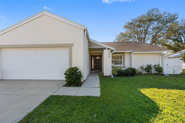 ranch-style house with an attached garage, a shingled roof, stucco siding, a front lawn, and concrete driveway