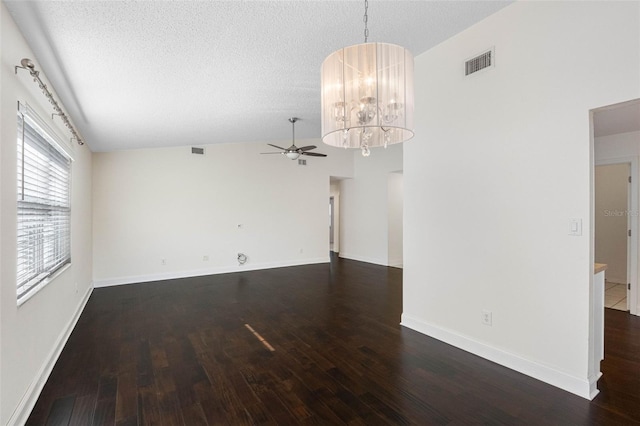 unfurnished room featuring wood finished floors, ceiling fan with notable chandelier, and visible vents