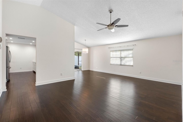 empty room with a ceiling fan, a textured ceiling, baseboards, dark wood-style flooring, and vaulted ceiling