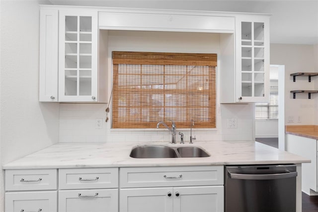 kitchen featuring dishwasher, glass insert cabinets, white cabinetry, and a sink