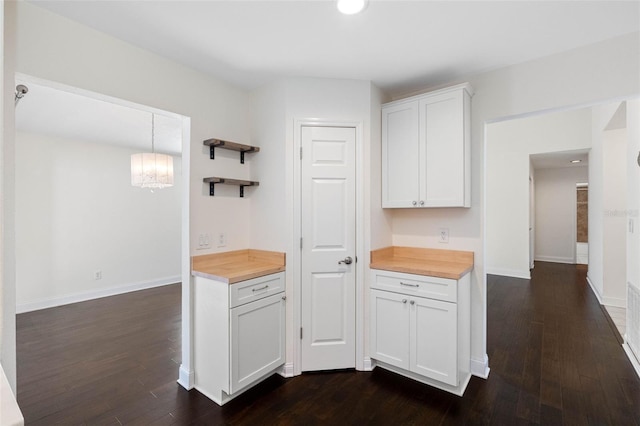 kitchen featuring white cabinetry, open shelves, dark wood-style floors, and wooden counters