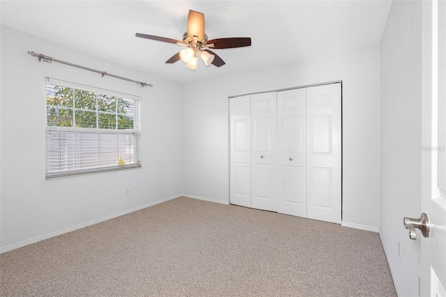 unfurnished bedroom featuring a closet, carpet flooring, ceiling fan, and baseboards