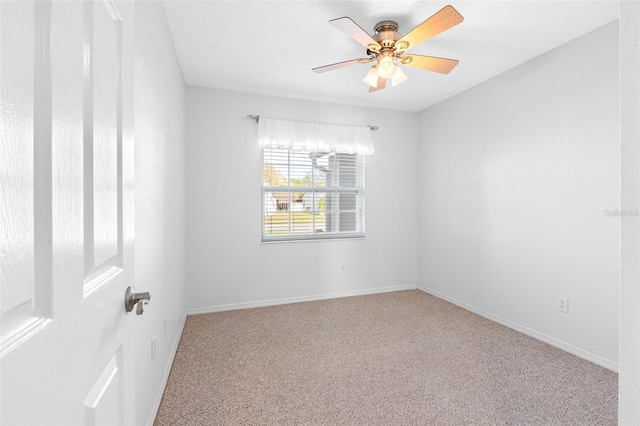 unfurnished room with a ceiling fan, carpet, and baseboards