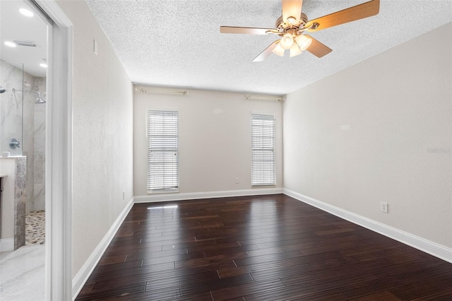 spare room with baseboards, a textured ceiling, ceiling fan, and wood finished floors