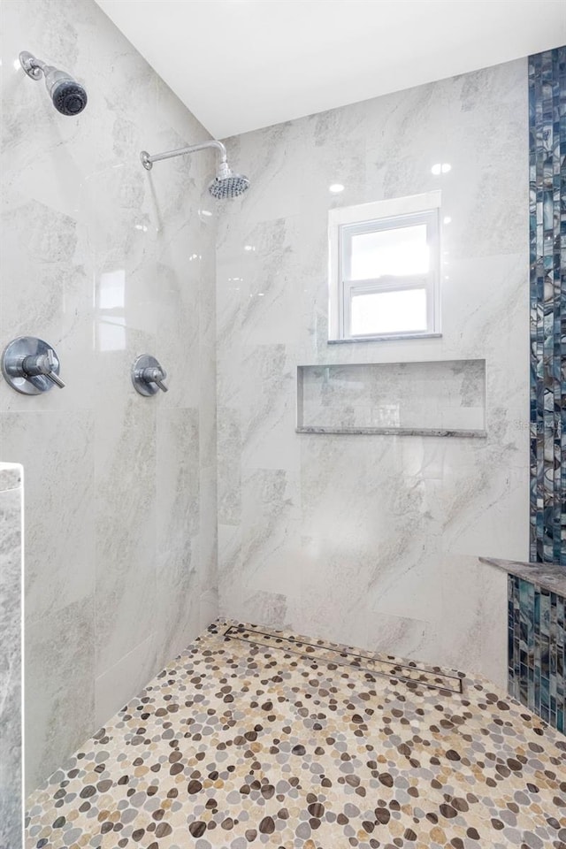 bathroom with a tile shower