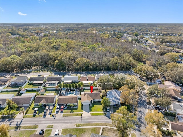 aerial view featuring a forest view and a residential view