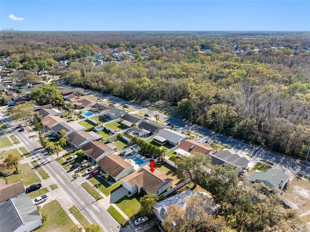 drone / aerial view featuring a forest view and a residential view