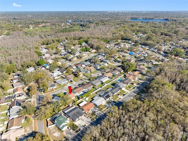 birds eye view of property with a forest view and a residential view