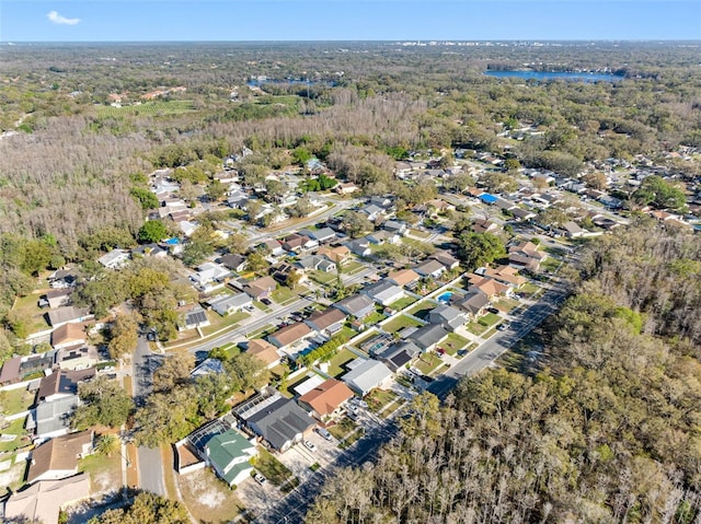 birds eye view of property featuring a residential view and a view of trees