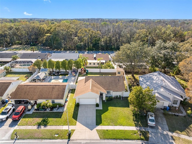 drone / aerial view featuring a residential view and a forest view