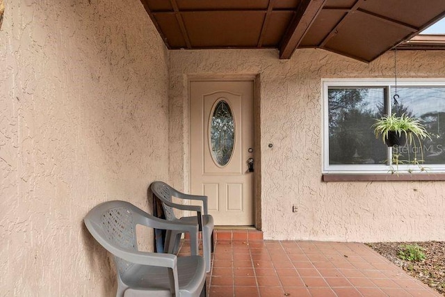 property entrance with stucco siding