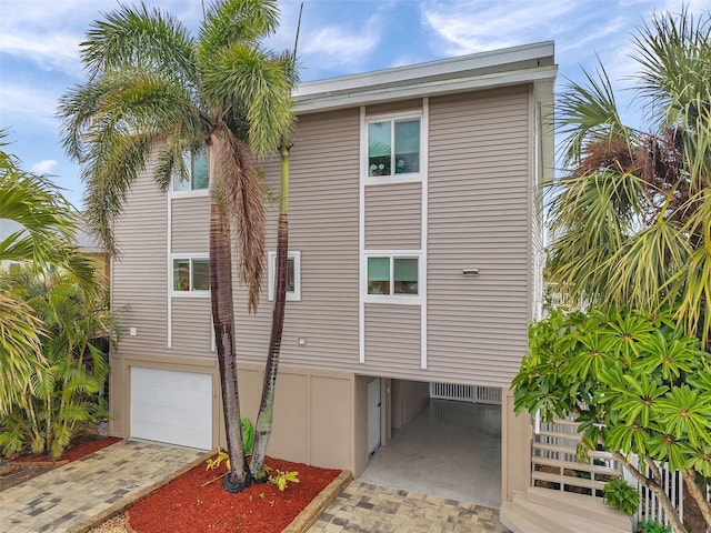 exterior space featuring decorative driveway and an attached garage