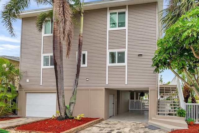 exterior space featuring stairway and an attached garage