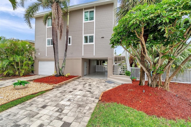 17404 1st St E, Redington Shores, FL 33708 - raised beach house featuring driveway, stairway, and a garage