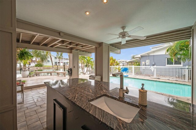 17404 1st St E, Redington Shores, FL 33708 - view of patio featuring a sink, ceiling fan, and fence