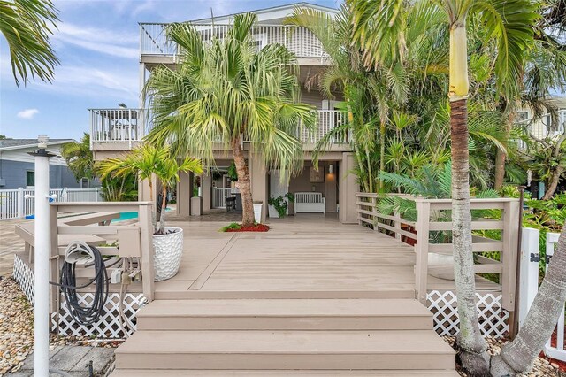 17404 1st St E, Redington Shores, FL 33708 - wooden terrace featuring radiator heating unit and fence