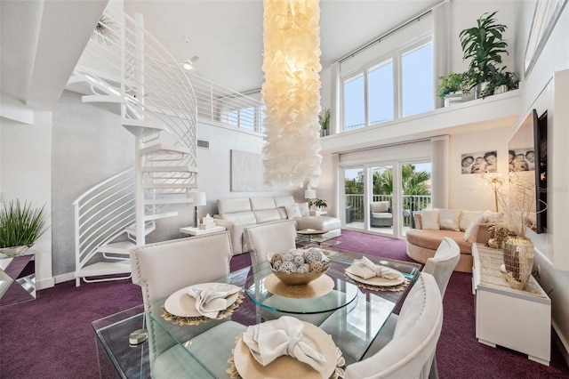 17404 1st St E, Redington Shores, FL 33708 - carpeted dining space featuring a high ceiling, stairway, and baseboards