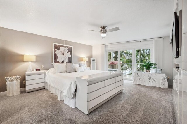 17404 1st St E, Redington Shores, FL 33708 - bedroom with light carpet, access to outside, and a ceiling fan