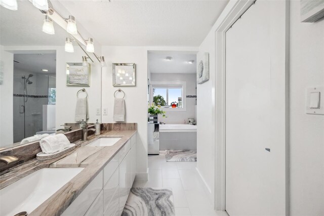 17404 1st St E, Redington Shores, FL 33708 - bathroom with a garden tub, tile patterned flooring, a shower stall, and double vanity